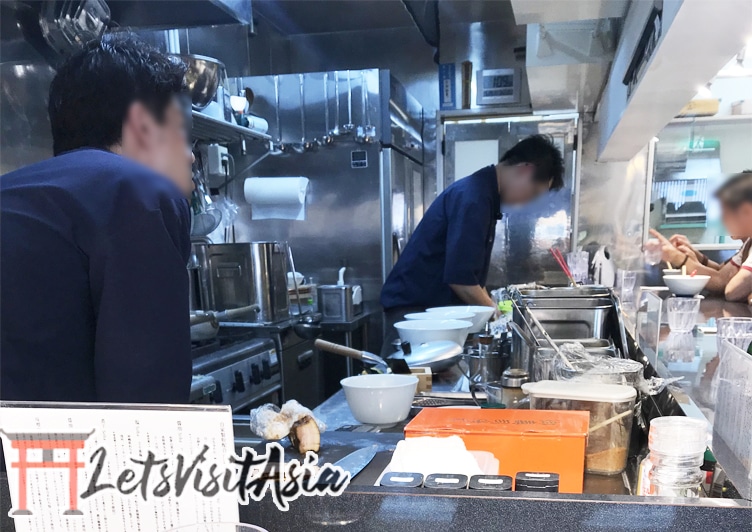 Inside Tsuta Ramen Restaurant showing the masters hard at work in the kitchen